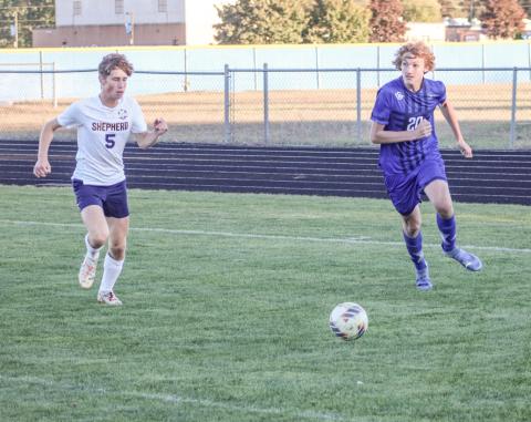 George Whittaker looks toward the front of the net as he closes in on the ball during last week’s district tournament game.