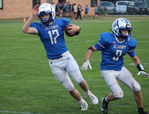 Caden McKeever cuts behind blocker Kolten Greaves during a recent Gladwin junior varsity football game.