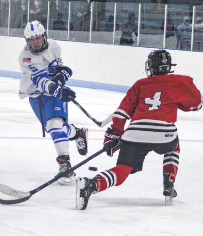 Gladwin’s Caden McKeever fires a shot past a defenseman for the FNV Griffins during the Flying G’s 4-2 victory last week.