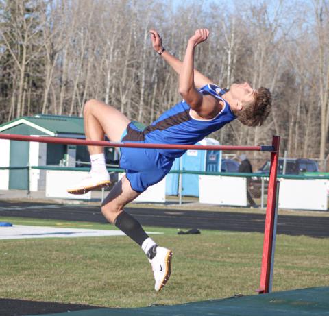 Gladwin’s Erik Roggow clears the bar in the high jump during last Wednesday’s meet at Clare.