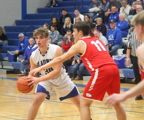 Gladwin’s Connor Dee, guarded by Beaverton’s Landon Love, looks for an open teammate to pass to.