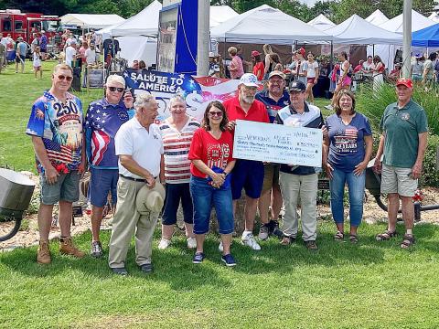 County Commissioner Mike Visnaw and County Veterans Affairs Director Ken Roberts team up to hold a big check that was donated to the Veterans Relief Fund Saturday. Also pictured: Mike Fitch, first tee shooter and George Alward, Chairman of the Gladwin County Veterans Council. Also, Sugar Springs Board of Directors Jeff Weeman, Craig Taunt, June Jucewicz, Sherri Visnaw, Tom Hug, and Eve Kaltz.