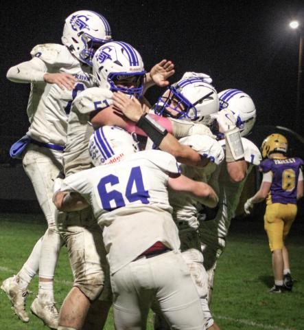 Jacob Pahl is mobbed by his teammates after catching a touchdown pass on the last play of the game Friday night to give Gladwin a 26-20 victory over Ogemaw Heights and the Jack Pine Conference Division 1 championship. OGEMAW