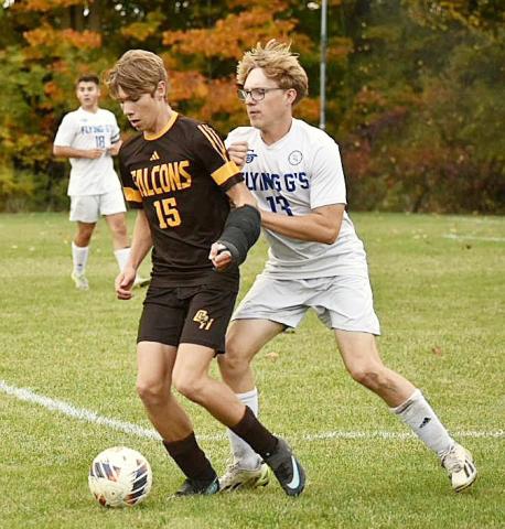 Gladwin’s Luken Binger applies defensive pressure during last Wednesday’s district tournament win at Ogemaw Heights. PHOTOS BY BETH ORR