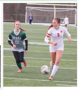 Beaverton’s Piper Carland races past a Clare defender and looks toward the net during last week’s season-opening tie.