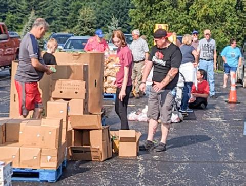 Volunteers sorting and assisting food into cars at Christ the King.