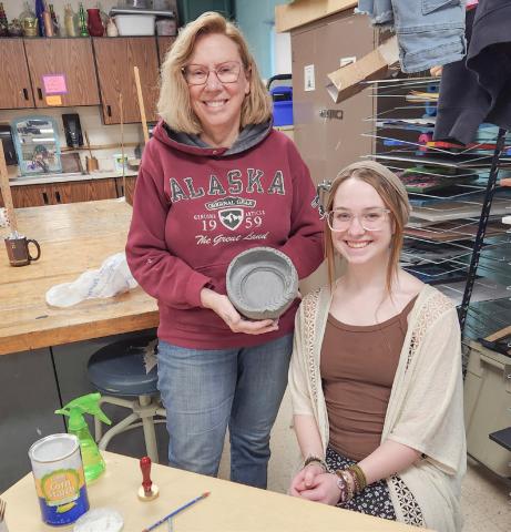 Art guild member Jan Berg-Rezmer and student leader Tori Johnson show off the first finished bowl for Empty Bowls 2025!