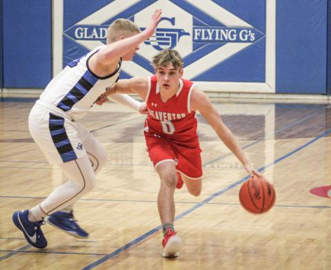 Gladwin’s Jayden Mieske applies defensive pressure to Beaverton ball-handler Caiden Loar during Round 1 of the basketball battle for Butch last Tuesday night. The Flying G’s pulled out a tough 57-49 victory.