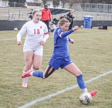 Gladwin’s Madisyn Lockwood gets ready to take a shot as Beaverton defender Sophia Milks closes in during last Ttuesday’s 3-1 victory for the Flying G’s.