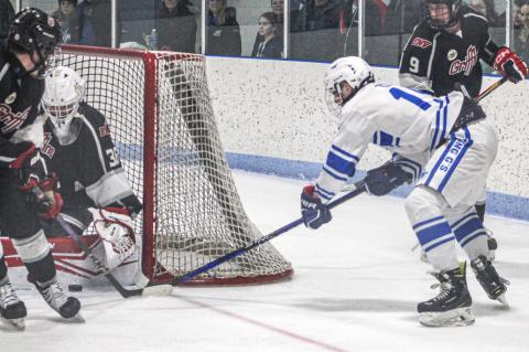 Gladwin’s Jacob Zeitz tries to stuff one in during a victory over the FNV Griffins earlier this season.