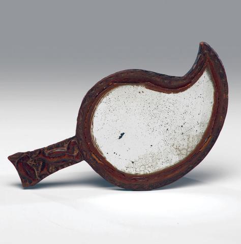 Broken mirrors don’t have to be bad luck. This one was made into a piece of folk art that still had its use. KOVELS.COM