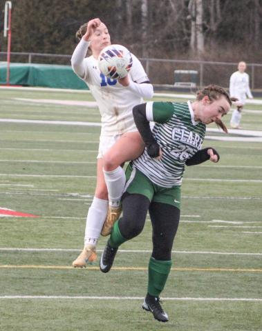 Gladwin’s Madisyn Lockwood takes flight to try to get control of the ball during Thursday’s 3-0 victory at Clare.