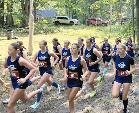 The Gladwin girls’ cross country team takes off at the start of a race last month at the Gladwin Conservation Area. The Flying G’s return to host a Jack Pine Conference jamboree today.