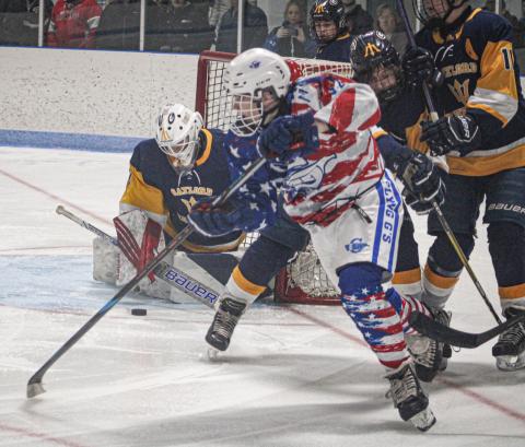 Gladwin’s Moe Newman slides a back-hand shot on goal during the third period of Satuday’s 10-2 victory over Gaylord on Military Appreciation Day.