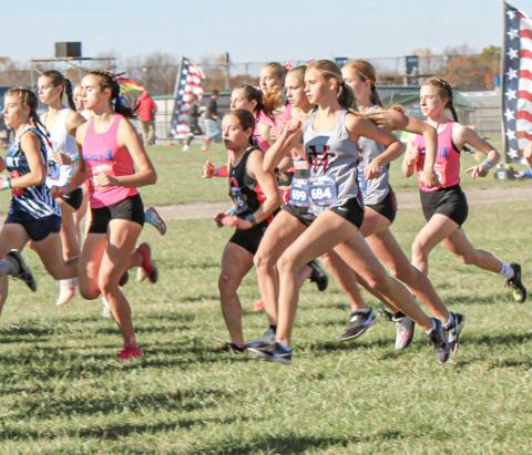 Gladwin seniors Abby Robinson and Lily Binger take off with the masses at the Division 2 state meet at Michigan International Speedway Saturday.
