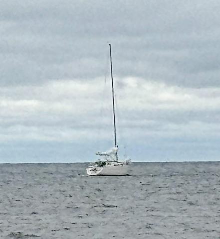 A sailboat remains stranded in Lake Huron, offshore of Point Au Gres, after two boaters from Ann Arbor ran aground and became stranded in rough water Tuesday. Michigan Department of Natural Resources conservation officers were able to safely rescue and return both boaters to shore.