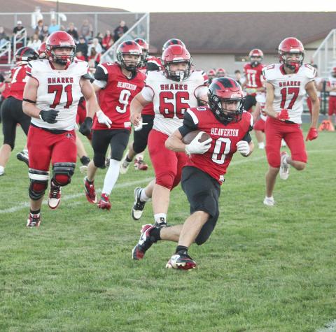Beaverton’s Ty Wicke runs away from a pursuing pack of massive St. Louis Sharks during Friday night’s victory.