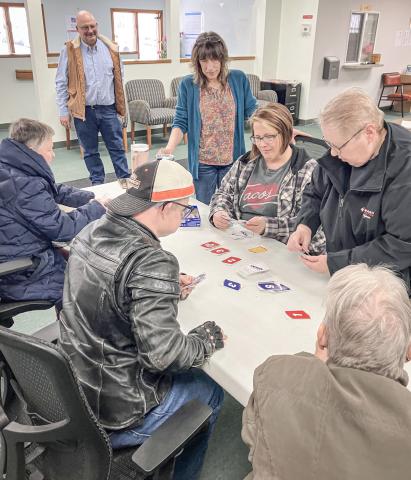 Billings Township Supervisor Tim Mester watches a card game that broke out at the Township Hall last Wednesday as part of Community Activity Day.