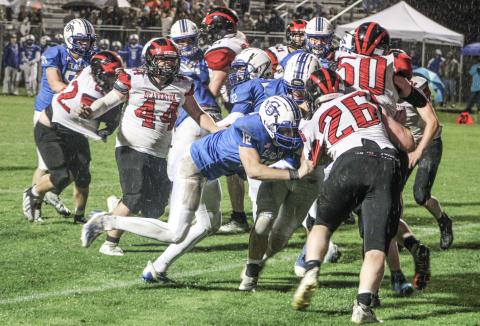 With a wet ball and a rain-soaked field, winning battles like this in the trenches lifted the Gladwin football team to a 50-0 victory over visiting Beaverton Friday night in The Battle For Butch.
