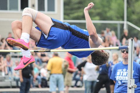 Clearing the pole in the high jump event.