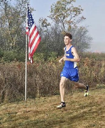 Gladwin’s Elijah Christensen ran past Old Glory and his own school record Saturday at the Veterans Serving Veterans Invitational.
