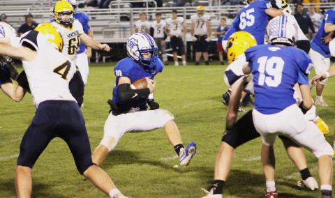Gladwin’s Jacob Pahl high steps into an opening in the Standish-Sterling defense during the fourth quarter.