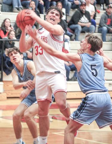 Beaverton’s Landon Love bashes through the swarming Meridian defense on his way to the basket during Friday night’s loss to the visiting Mustangs. BEAVERTON