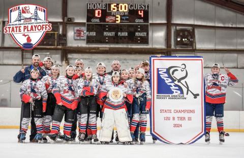 The Gladwin Gladiators hold their MAHA state championship banner on March 3. Pictured are front row, from left: Bronson Dennings, Adalynn Lechner, Payton Card, Maddyson Stalker, Avery Osentoski; second row, from left: Addison Anderson, Noah Scott, Danielle Cornell, Mia Freeman, Donovan Loose; back row, from left: head coach Ryan Harris, Mason Dern, coach Jason Newman, coach Jason Osentoski; holding banner, from left, Korbin Harris, and Preston Newman.