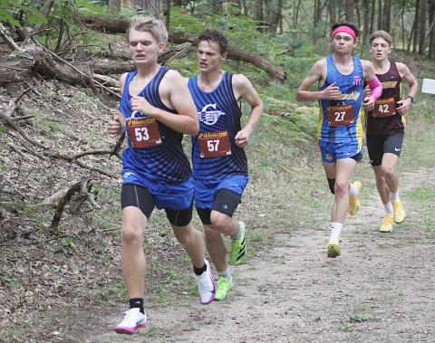Gladwin’s Nathan Muma and Jeffery Sisson race through the middle of the course on the way to earning medals at the Cedar Bend Invitational Saturday at the Gladwin County Recreation Area.