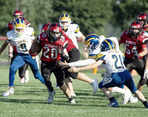 Beaverton’s Remington Brethour tries to elude a pair of would-be Evart tacklers during the Beaverton JV football team’s 0-0 tie Thursday. PHOTO BY JESSICA KELLER