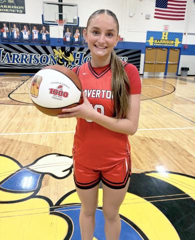 Beaverton junior Myah Hubble shows off the personalized basketball she received Thursday night after passing the milestone for 1,000 career points in a 78-48 victory at Harrison. Needing 17 points pregame to reach the magic number, Hubble finished with a game-high 37.