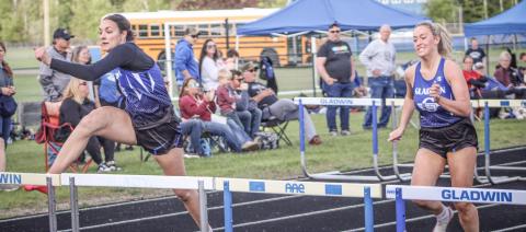 Gladwin’s Ava Gary and Lizzie Haines race to a 1-2 finish in the 100 hurdles during the Legends Track Meet Friday.