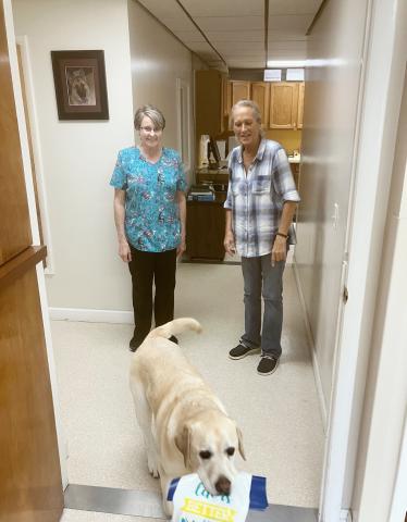 Becky Priemer and Terri Taylor send Lance off on a delivery during another work day at the Gladwin Veterinary Clinic. All three longtime employees of the business will be retiring on Aug. 28.
