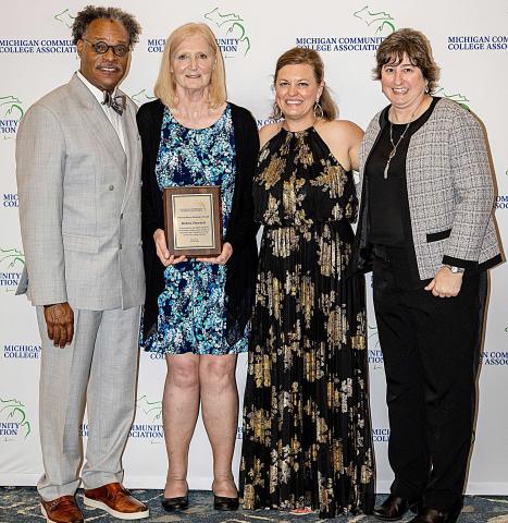 Pictured left to right: Dr. L. Marshall Washington, MCCA Board Chair; Dr. Debra Daniels, 2026 Outstanding Alumnus Award recipient; Brandy Johnson, President of MCCA; and Dr. Michelle Allmendinger, President of Delta College.