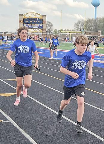 Bentley Grice and WiIliam Kruske accomplish a successful handoff in their relay.