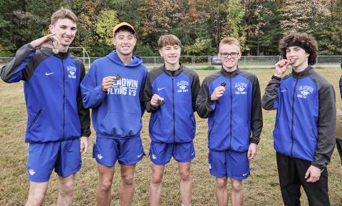 Gladwin’s (left to right) Elijah Christensen, Caleb Palmreuter, Ben Verellen, John Whitman and Myles Robinson enjoy an invitational victory at Meridian.