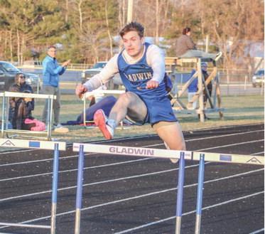 Gladwin’s Colton Pfenninger hurdles his way to a victory during the first outdoor meet of the season last Wednesday.