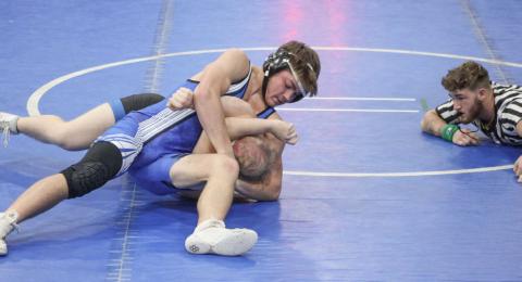 Gladwin’s Lorcan Keatley applies a headlock during a recent match. The Flying G’s swept a tri-meet at Evart to open the season last week.