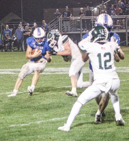 Gladwin quarterback Colton Pfenninger tries to bounce off a hit during Friday night’s dramatic loss to visiting Clare.