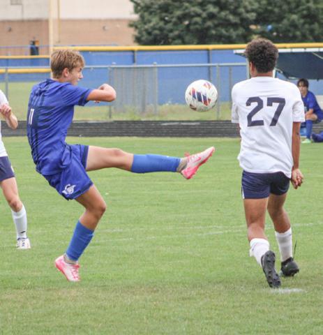 Gladwin’s Keaton Mausolf boots one out of the air during a recent game.