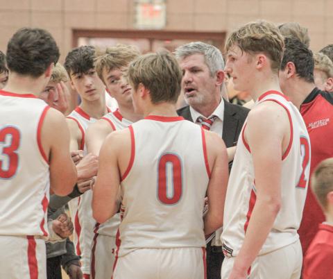 Beaverton coach Shad Woodruff talks strategy with the troops during a timeout in the waning moments of Friday night’s loss to Bullock Creek.