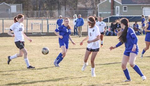 Gladwin’s Hallee LaBrosse draws a bead on the bouncing ball while surrounded by Bullock Creek defenders during Thursday’s victory.