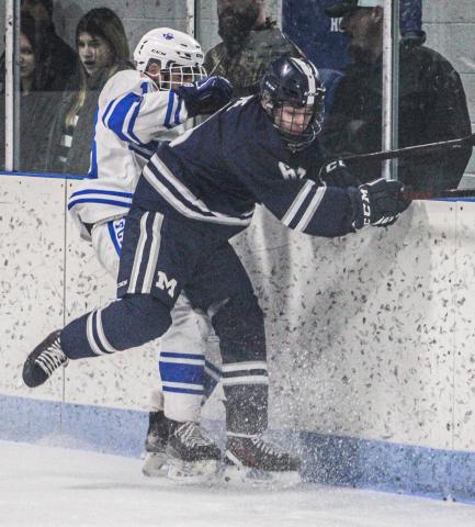 Gladwin’s Drew von Matt checks a Marysville defenseman behind the Vikings net during a rugged first period for the home team on Saturday.