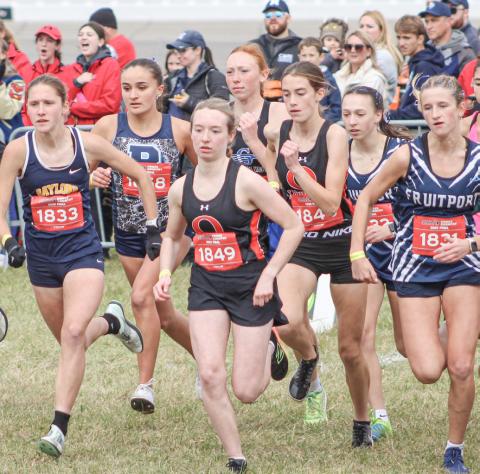 Gladwin’s Alanis Povey takes off with the crowd after the starting gun went off at the Division 2 State Meet Saturday at Michigan International Speedway.