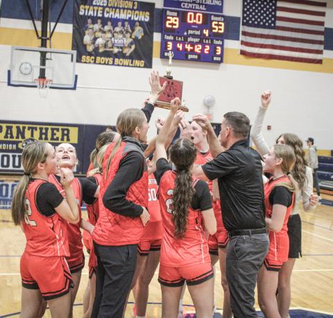 Beaverton’s players and coaches celebrate winning the Jack Pine Conference championship on the court at Standish.