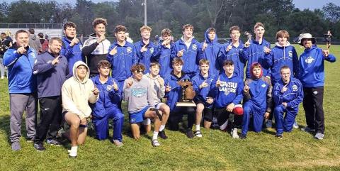 The Gladwin Boys Track and Field team with their freshly won 2023 MHSAA Regional Trophy.