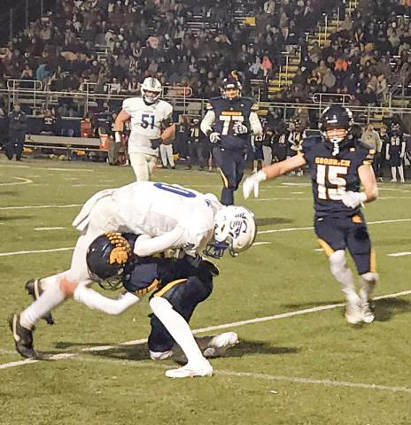 Gladwin receiver Bronson Bigham is denied more yards after the catch during Friday night’s regular-season finale at Goodrich.