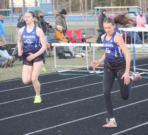 Gladwin hurdlers Charlotte Mawhorter (left) and Bree Visser sprint to the finish line during a recent meet.