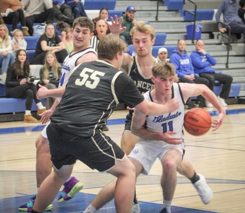 Gladwin’s Trace Corlew runs into a wall in the lane during Friday night’s victory over visiting Bullock Creek.