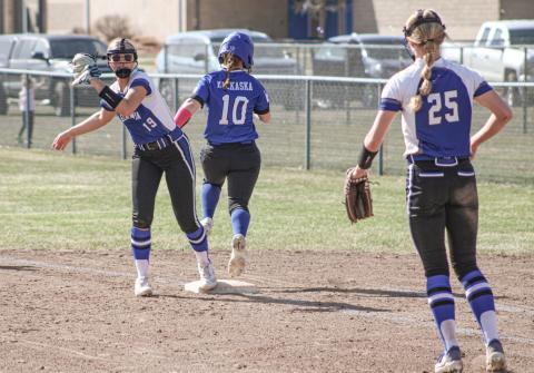 Gladwin’s Adree Ritchie completes a put-out at first base under the watchful gaze of pitcher Tessa Cameron.